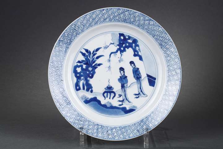 Chinese blue and white porcelain plate with two long Eliza in a garden in front of a censer
